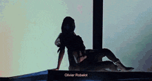 a silhouette of a woman with the name olivier robelot in the corner
