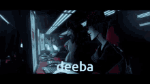 a man in a red hoodie is sitting in a dark room with the word deeba written on the screen