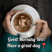 a person holding a cup of coffee with a picture of a man on it