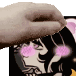 a close up of a person 's hand holding a picture of a girl with pink cheeks .