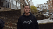a man wearing a black hoodie with the word stark on the front