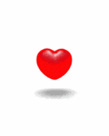a broken red heart is floating in the air