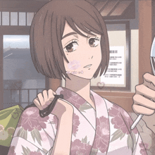 a girl in a kimono looks at herself in the mirror