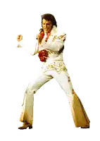 a man in a white suit is singing into a microphone with his fist in the air