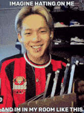 a man wearing a red and black shirt that says loo92 on it