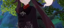 a girl with long dark hair is standing in front of trees .