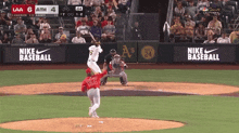 a baseball game is being played in front of a nike baseball sign