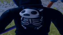 a person wearing a black hoodie with a skeleton bear on the back