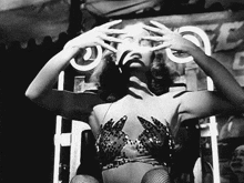 a black and white photo of a woman in a sequined top