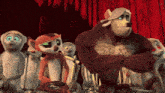 a group of cartoon characters are standing in front of a red curtain and one of them has the letter a on his chest