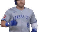 a baseball player wearing a kansas city jersey and a blue helmet