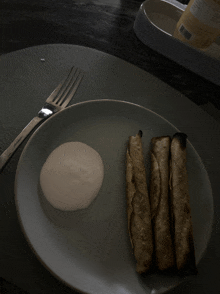 a plate of food with a fork and a bottle of mayonnaise