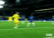 a blurry picture of a soccer game with the word heiitse on the bottom right