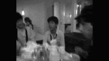 a group of people are sitting at a table in a room .