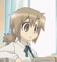 a close up of a cartoon girl wearing a white shirt and a blue bow tie .