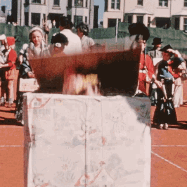 a group of people are gathered around a box that says ' a ' on it