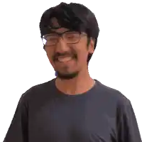 a man with glasses and a beard is wearing a blue shirt