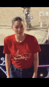 a woman wearing a red lena mua t-shirt