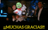 a man with a green mask is holding a trophy in front of a crowd and the words muchas gracias