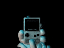 a game boy with a ghost face on it