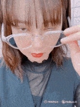 a woman wearing glasses with a watermark that says minimax