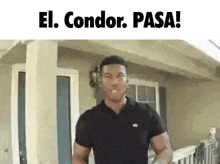a man in a black shirt is standing in front of a house with the words el condor pasa below him