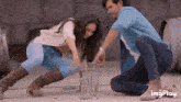 a man and a woman are playing with wine bottles and the word imgplay is on the bottom of the screen