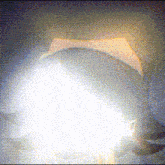 a close up of a person 's face with a glowing light behind them