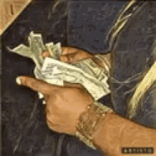 a man is holding a bunch of money in his hands in a painting .