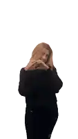 a woman in a black sweater making a heart shape with her hands