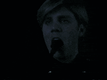 a close up of a person 's face with a light coming out of their mouth