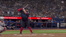 a toronto blue jays baseball player swings his bat