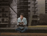 a man sitting on the floor with the words george misses marie behind him