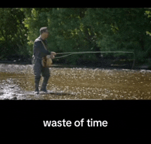 a man is fishing in a river with the words " waste of time " above him