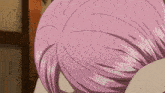 a close up of a person 's pink hair with a brown background