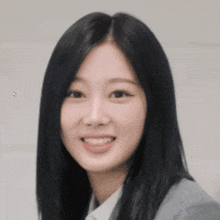 a close up of a woman 's face with long black hair .