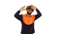 a man with a beard wearing a black and orange shirt is dancing with his arms outstretched