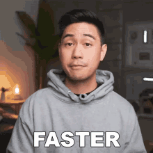 a man in a grey hoodie has the word faster written on his chest