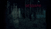 a man in a tuxedo is smiling in front of a dark forest with the words bezdari oguzki written in red
