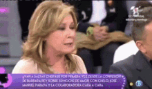a woman is talking on a television screen with a purple background