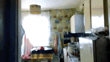 a kitchen with a table and a refrigerator in the background