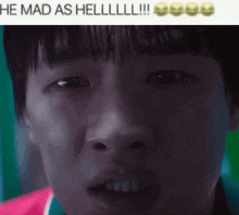 a close up of a person 's face with the caption he mad as hell .