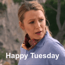 a woman in a blue shirt says " happy tuesday "