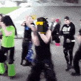 a man wearing a black shirt that says dark stands in a crowd