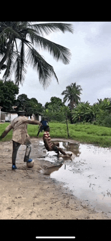 a man is kicking a soccer ball in a puddle of water