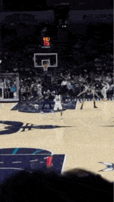 a basketball game is being played in a stadium with a scoreboard that shows the score at 13