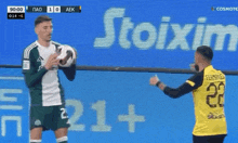 a soccer player in a green jersey with the number 2 on it