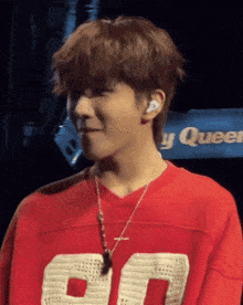 a man wearing a red shirt with the number 50 on it