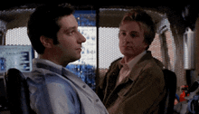 a man in a wheelchair talking to another man