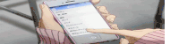 a person in a pink sweater is holding a cell phone with a foreign language on the screen